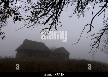 Alone house on foggy meadow Stock Photo
