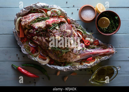 Raw lamb leg, marinated with herbs Stock Photo