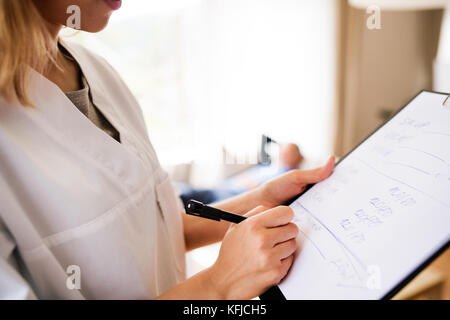 Health visitor and senior man during home visit. Stock Photo