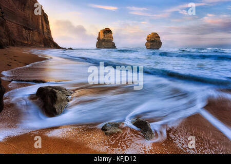 Sunrise at Gibson steps beach on Great Ocean road twelve apostles marine park with view of two standing rocks disconnected from australian coast. Stock Photo