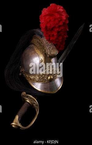Composition with saber (sabre, cavalry sword) of French infantry officer (model 1855) and French cuirassier helmet (1836). Path on dark background. Stock Photo