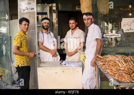 Tehran, IRAN - August 16, 2017 Group of bakery shop workers standing in front of bakery shop. Stock Photo