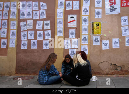 Some girls rest under some posters where says we voted to be free, in Barcelona. On the referendum organized by Puidemont in Catalonia where the indep Stock Photo
