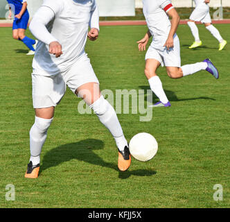 Men are playing soccer outdoor in summer Stock Photo