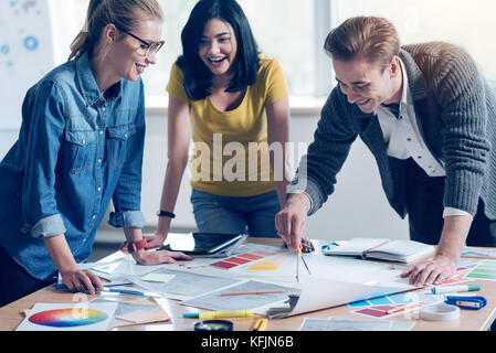 Handsome male person working in female collective Stock Photo