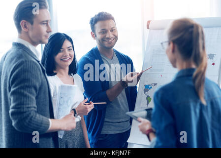 Group of positive people that listening their coworker Stock Photo