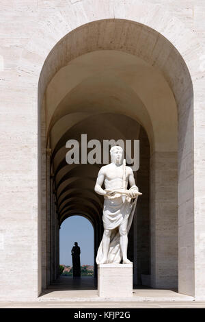 Classical statues surround the Palazzo della Civilta Italiana, known as the white marble square colosseum (Colesseo Quadrato).  EUR, Rome, Italy. Stock Photo