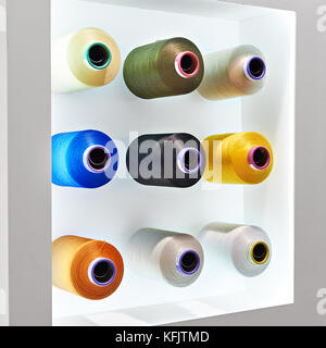 Bobbins with colored thread for industrial textile machines Stock Photo