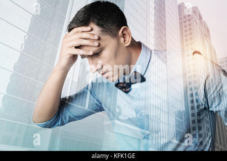 Serious depressed man holding his forehead Stock Photo