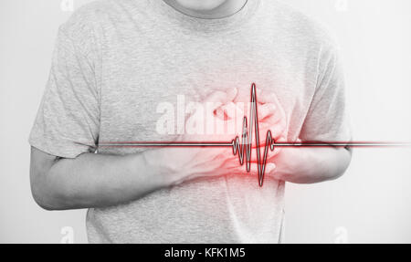 a man touching his heart, with heart pulse sign, concept of heart attack, and others heart disease Stock Photo