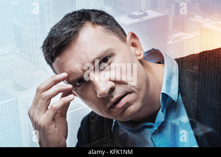 Cheerless depressed man feeling upset Stock Photo