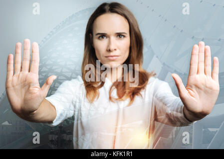Selective focus of female hands touching transparent screen Stock Photo
