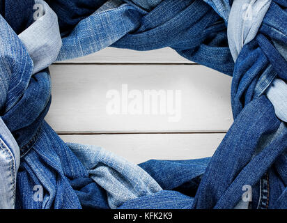 frame stylish plaits and braids woven and twisted from a variety of blue jeans on white background Stock Photo