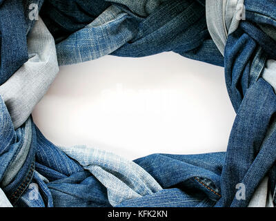 frame stylish plaits and braids woven and twisted from a variety of blue jeans on white background Stock Photo