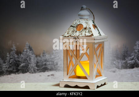christmas lantern and snowy firs in the background Stock Photo