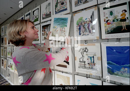 Auctioneer Catherine Southon holds examples from the Smilby cartoon collection, including works that appeared in Playboy, as she sets up her sale room in Farleigh, Surrey, ahead of their auction on the 1st of November. Stock Photo