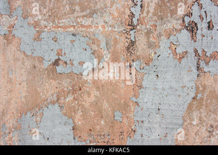 Finishing  gray ,red , plaster, concrete structure,  cement background. The cracks on the wall, paint shabby Stock Photo