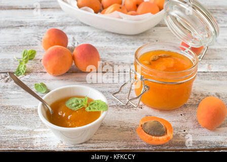 jars with homemade apricot jam on a light wooden background Stock Photo