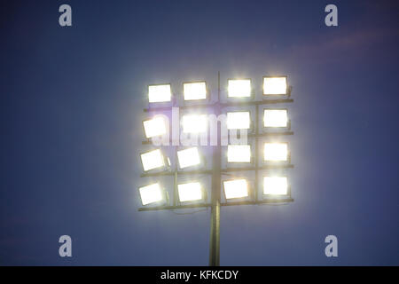 Stadium lights tower on dark blue sky background Stock Photo