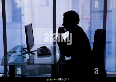 Side view of businessman using computer in office Stock Photo