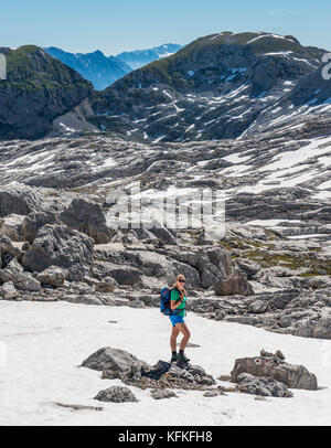 Hiking on the hiking trail to the Königssee and the Wassereralm, Steinernes Meer with snow in spring Stock Photo