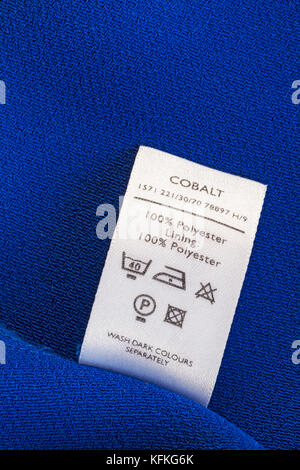100% polyester label in woman's red clothing with wash care symbols and ...
