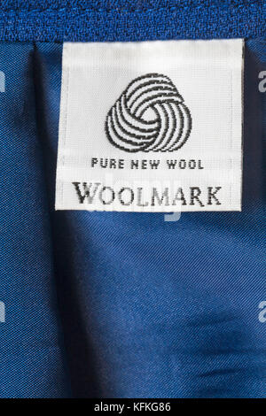 Pure New Wool logo Woolmark label in woman's blue suit Stock Photo