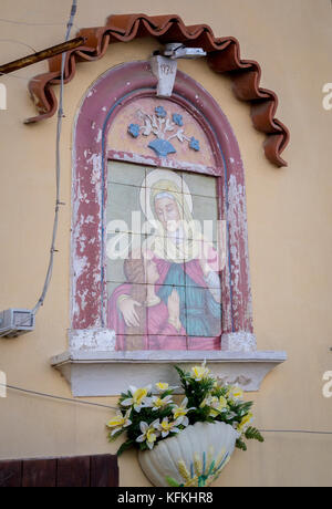 Painted wall fresco of Madonna and child on a rendered building exterior in Marina Grande, in Sorrento, Italy. Stock Photo