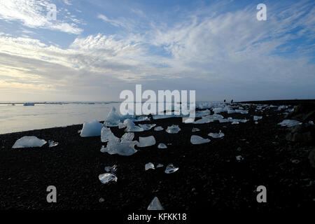 Washed up icebergs and photographers on Diamond Beach at sunrise, Jokulsarlon near Vik, Vatnajokull, South Iceland, Europe Stock Photo