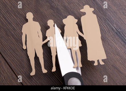 Scissors cutting paper family representing family divorce Stock Photo