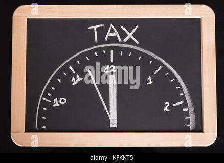 Tax time concept written on small blackboard Stock Photo