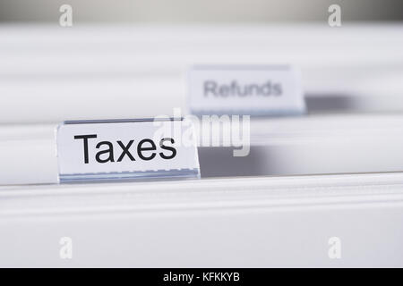 Closeup of Taxes and Refunds tabs on folders Stock Photo