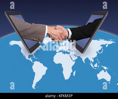 Business handshake emerging from digital tablets on world map against blue background. Source of reference map: http://visibleearth.nasa.gov/view.php? Stock Photo