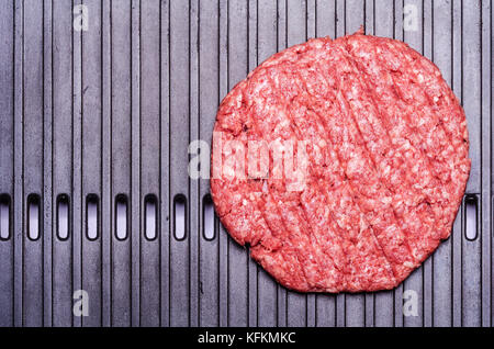 raw burger patty on a metal background Stock Photo