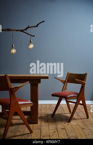 urban design branch lamp vintage chairs on wooden table Stock Photo