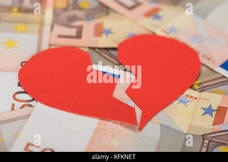 Closeup of red broken heart on euro banknotes Stock Photo