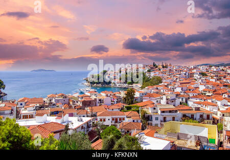 Sunset over Skiathos town on Skiatos Island, Greece. Beautiful view of the old town with boats in the harbour. Stock Photo