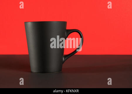 Black coffee cup. On black table and red background with copy space Stock Photo