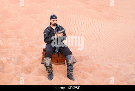 man, dressed as a pirate, in a desert Stock Photo