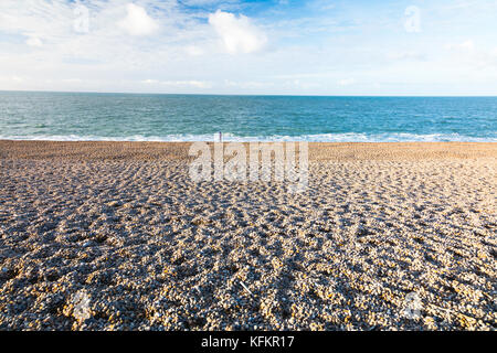 A lone figure on Chesil Beach Stock Photo