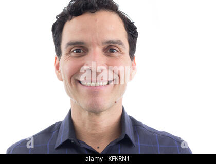 man in face portrait. Smiling. White teeth. He is wearing a blue shirt. Stock Photo