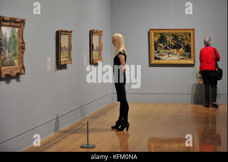 London, UK. 30th Oct, 2017. Visitors at a preview of 'Impressionists in London, French Artists in Exile (1870-1904)' at Tate Britain. The exhibition brings together over 100 works by Monet, Tissot, Pissarro and others in the first scale show of French artists who sought refuge in Britain during the Franco-Prussian War and shows views of London as seen through French eyes. The exhibition runs 2 November 2017 to 29 April 2018. Credit: Stephen Chung/Alamy Live News Stock Photo