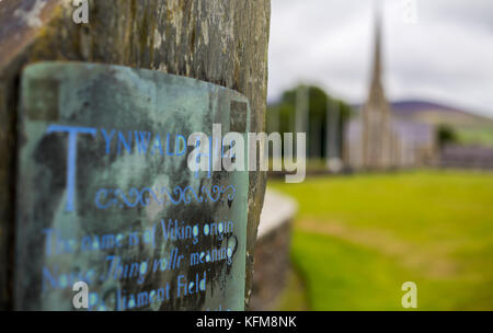 Manx Heritage sign at Tynwald Hill, with St John's church in the background, St Johns, Isle of Man. Stock Photo