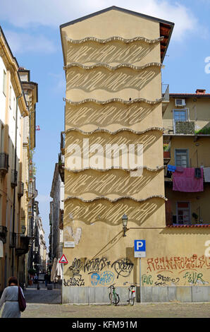 Art installation on gable end of old four-storey residential building in Turin, Italy Stock Photo