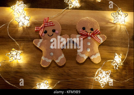 christmas gingerbread men decorations surrounded by fairy lights stock photo - Christmas Gingerbread Men Decorations christmas gingerbread men decorations surrounded by fairy lights stock photo - Christmas Gingerbread Men Decorations