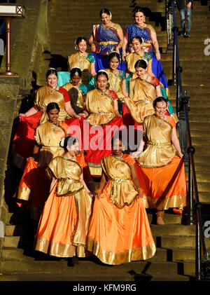 A group of Indian dancers walk down the steps into Princes Street Gardens to perform at the annual Diwali festival in Edinburgh. Stock Photo