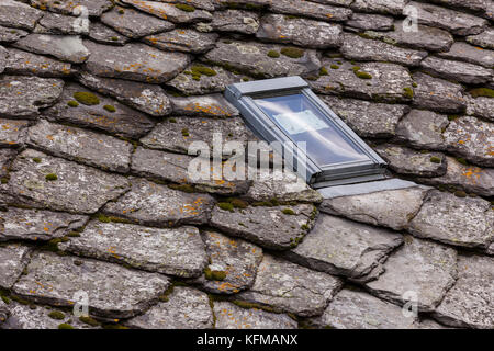 ST. NIKLAUS, SWITZERLAND - Modern skylight in traditional slate roof on building. Stock Photo