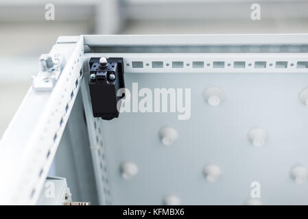 Electric light lamp in industrial enclosure, power distribution industry. Stock Photo