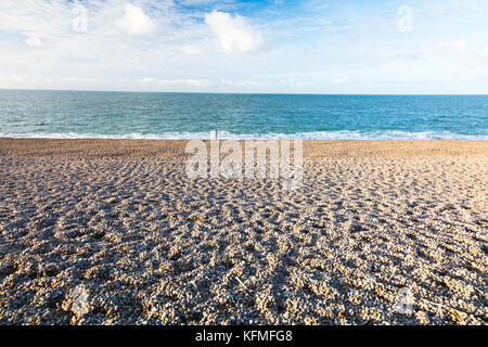 Figure on Chesil Beach, Dorset, England, UK Stock Photo