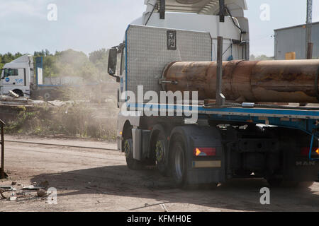 Decommissioned pipe sections used in the North Sea oil and gas industry delivered to Norfolk scrap metal yard in UK by ARR Craib haulage. Stock Photo